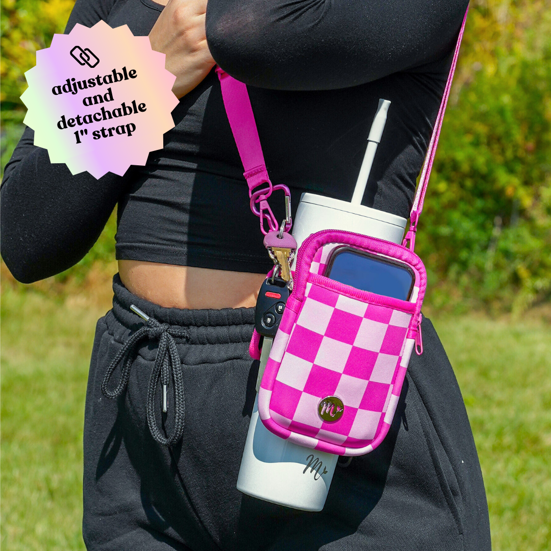 30 oz White Tumbler with Pink Checkered Sling and Adjustable Strap - The image highlights the adjustable and detachable 1-inch strap of the pink checkered sling. The pouch provides handy storage for essentials like keys and a phone, offering a stylish and functional way to carry your tumbler during outdoor activities