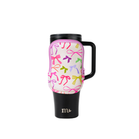 Travel mug with colorful bow pattern on a white background